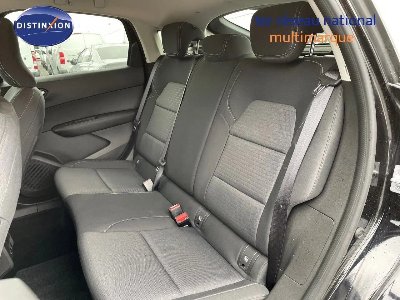 Vue intérieure côté droit des sièges arrière noirs du Renault Arkana 1.3 TCE 140 Evolution 2023 avec ceinture de sécurité visible.