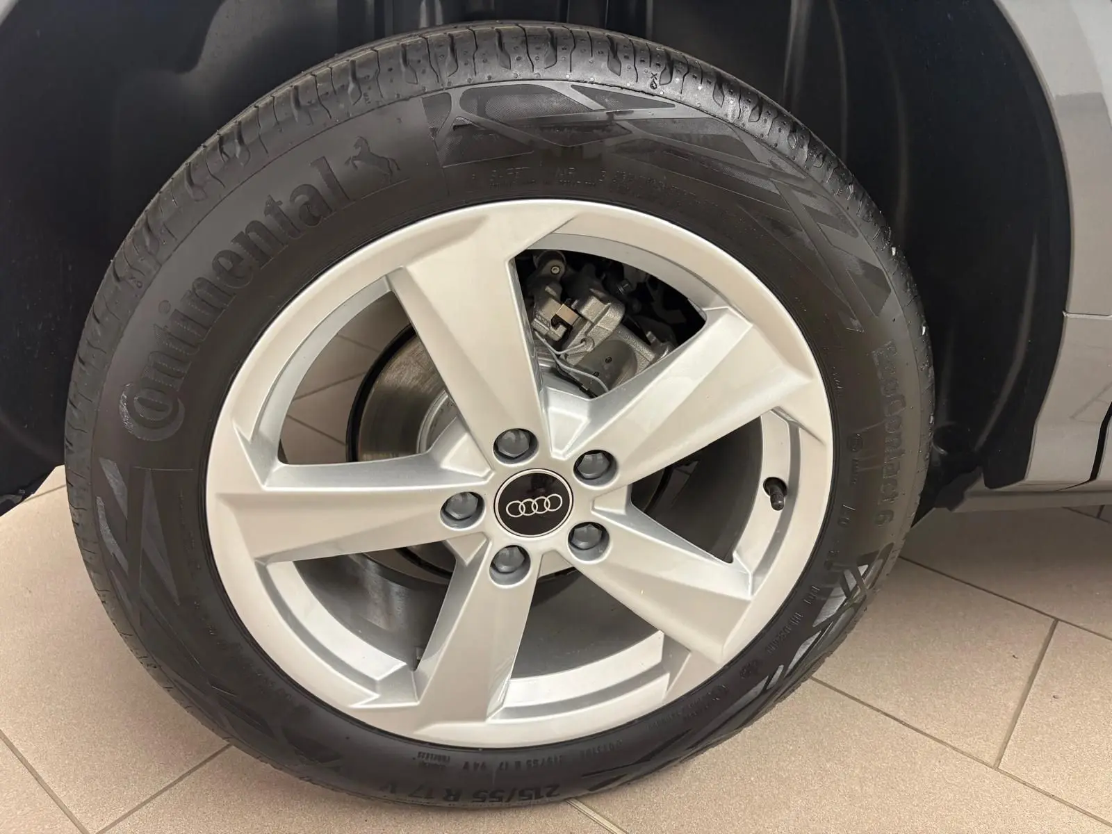 Gros plan sur la roue avant droite de l'Audi Q2 35 TFSI S Line 2026 en gris Daytona, avec jante alliage cinq branches.