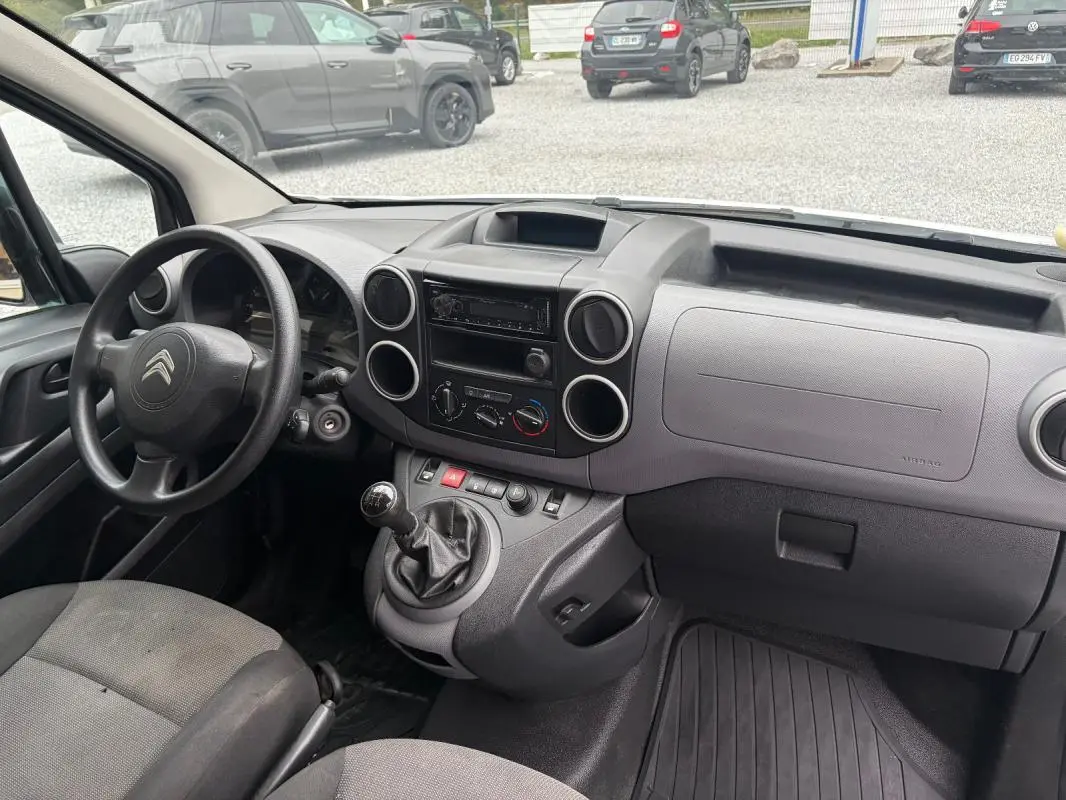 Vue intérieure côté conducteur du tableau de bord gris et levier de vitesses manuel du Citroën Berlingo Fourgon blanc de 2018.