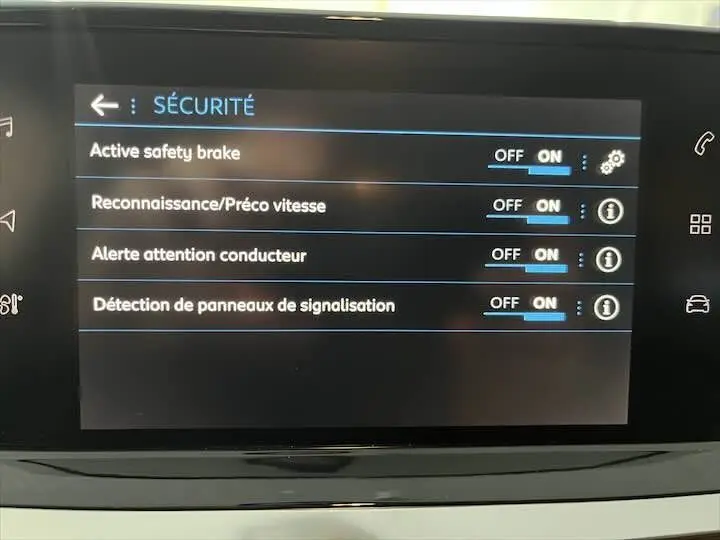 Écran tactile intérieur du Peugeot 208 2022 affichant les options de sécurité activées en français.