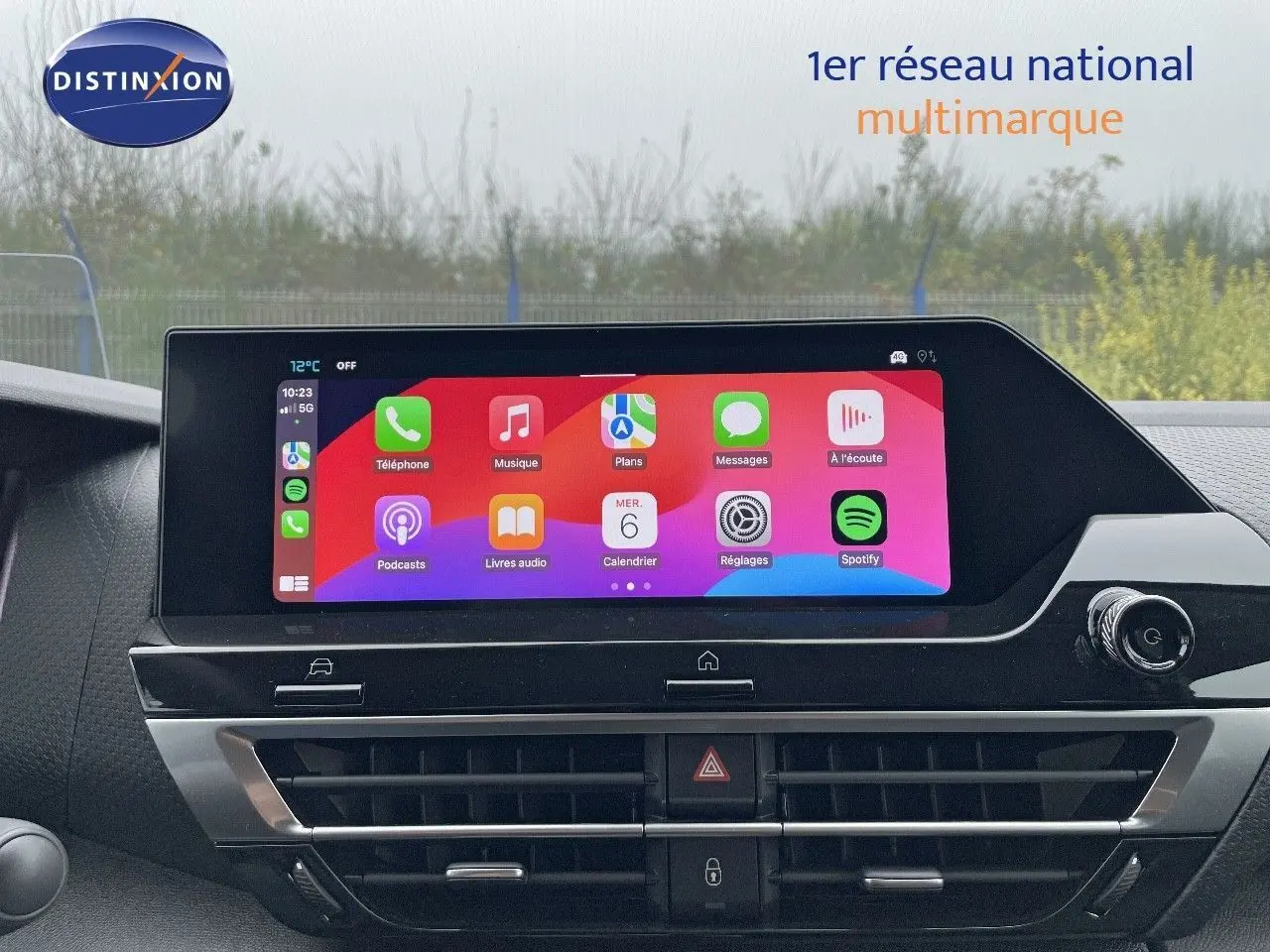 Écran tactile central allumé avec interface Apple CarPlay dans le tableau de bord d'une Citroën C4 blanche.