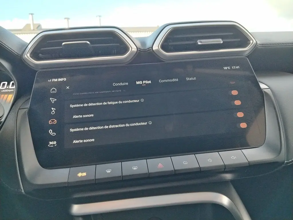 Vue rapprochée de l'écran tactile central du MG MOTOR ZS 1.5 l Hybrid + 197 LUXURY avec interface de sécurité conducteur.