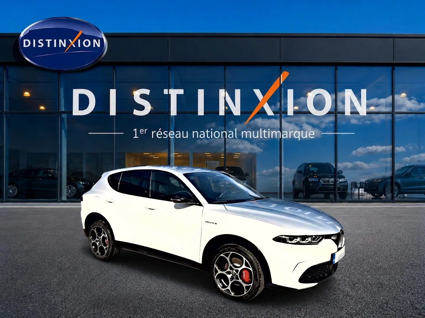 Alfa Romeo Tonale blanc en 3/4 avant droit, jantes alu distinctives et vitres arrière surteintées, devant showroom Distinxion.