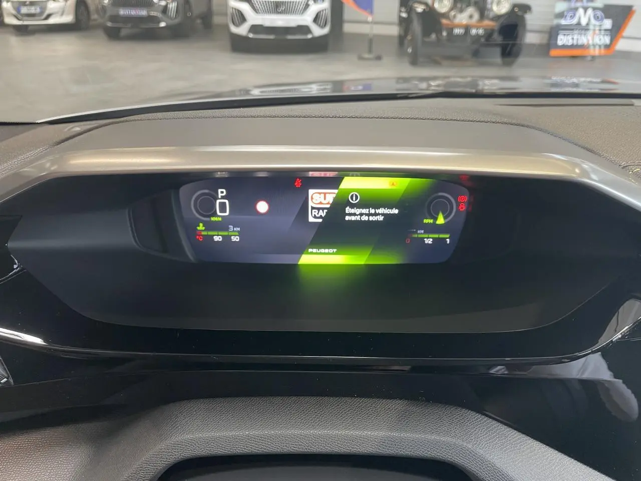 Tableau de bord numérique de la Peugeot 308 GT 2026 avec affichage digital moderne et éclairage vert.