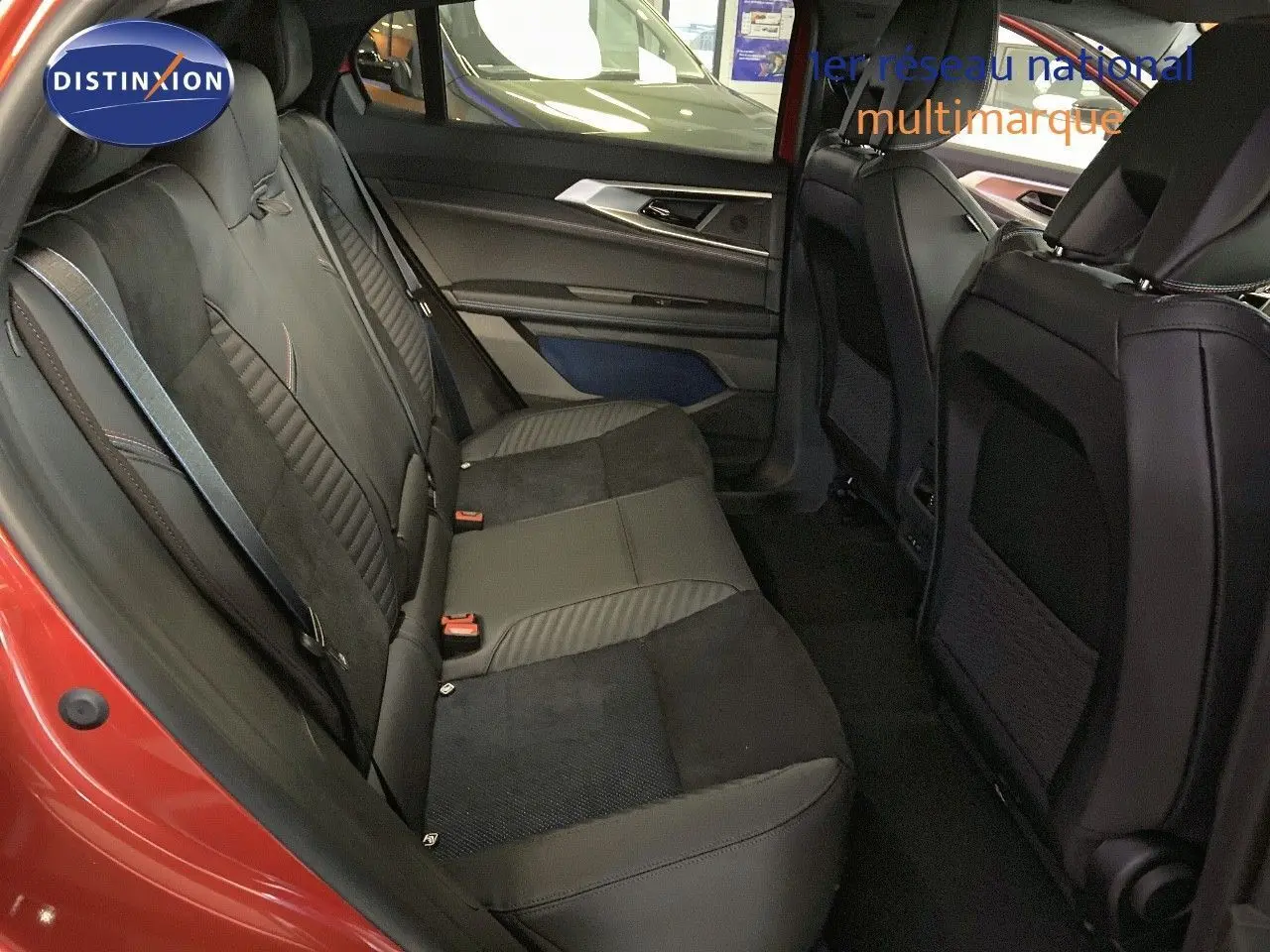 Vue intérieure arrière montrant les sièges noirs en cuir et alcantara du Renault Rafale rouge flamme 2024.