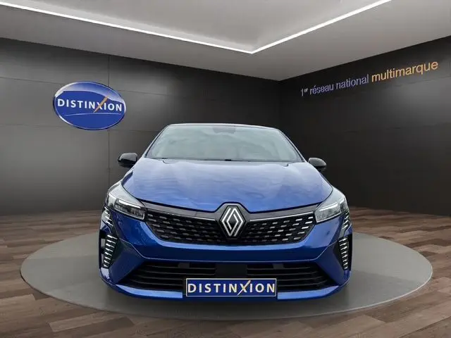 Vue frontale d'une Renault Clio V E-Tech Full Hybrid 145ch en bleu Iron, avec calandre noire et éclairage LED Pure Vision.