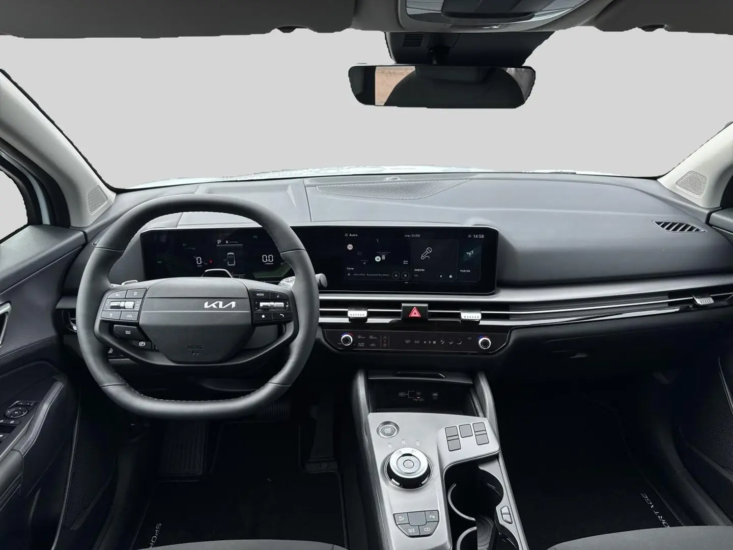 Vue intérieure avant du Kia Sportage 1.6 hybride 239 active, tableau de bord moderne avec écran tactile et volant cuir noir.