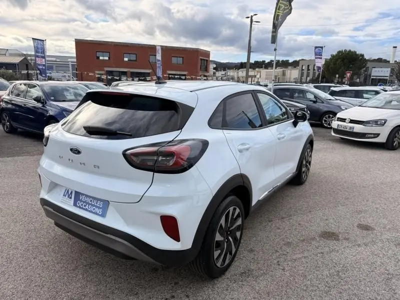 Vue 3/4 arrière droite d'un Ford Puma blanc 2026 avec feux arrière sombres et jantes alliage distinctives.