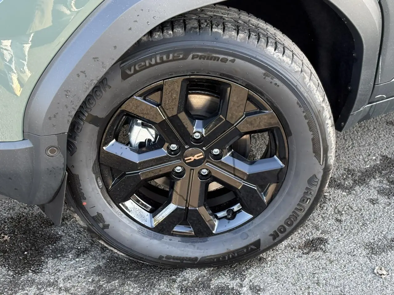 Gros plan sur la jante alliage noire 17 pouces du Dacia Duster kaki, avec pneu Hankook Ventus Prime 4 visible.