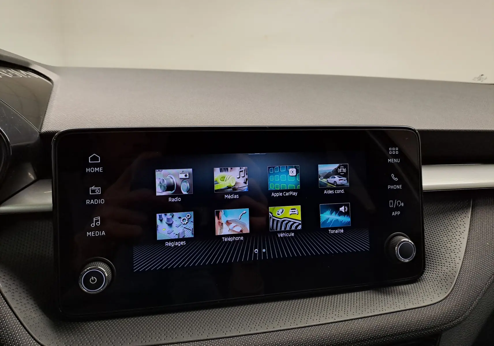 Écran tactile central de la Skoda Fabia 2025 affichant les menus radio, médias, Apple CarPlay et aides à la conduite.