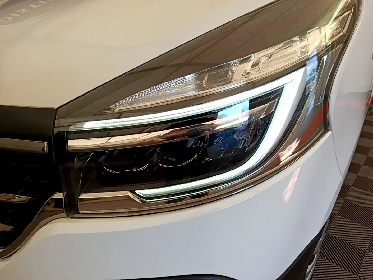 Gros plan sur le phare avant droit LED du Renault Trafic Fourgon blanc, soulignant son design moderne et précis.