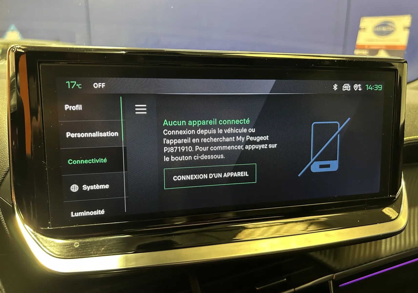 Écran tactile central du Peugeot 2008 2024 affichant le menu connectivité, avec cadre noir brillant et éclairage d’ambiance violet.