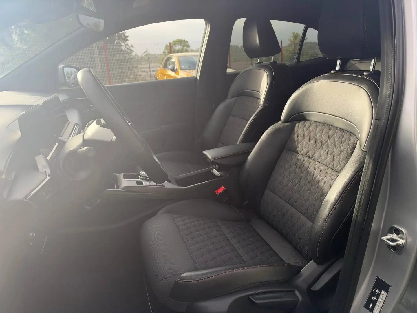 Vue intérieure côté conducteur du MG3 1.5 Hybrid+ 195ch Luxury 2025 en Cosmic Silver, sièges noir simili cuir/tissu avec surpiqûres rouges.
