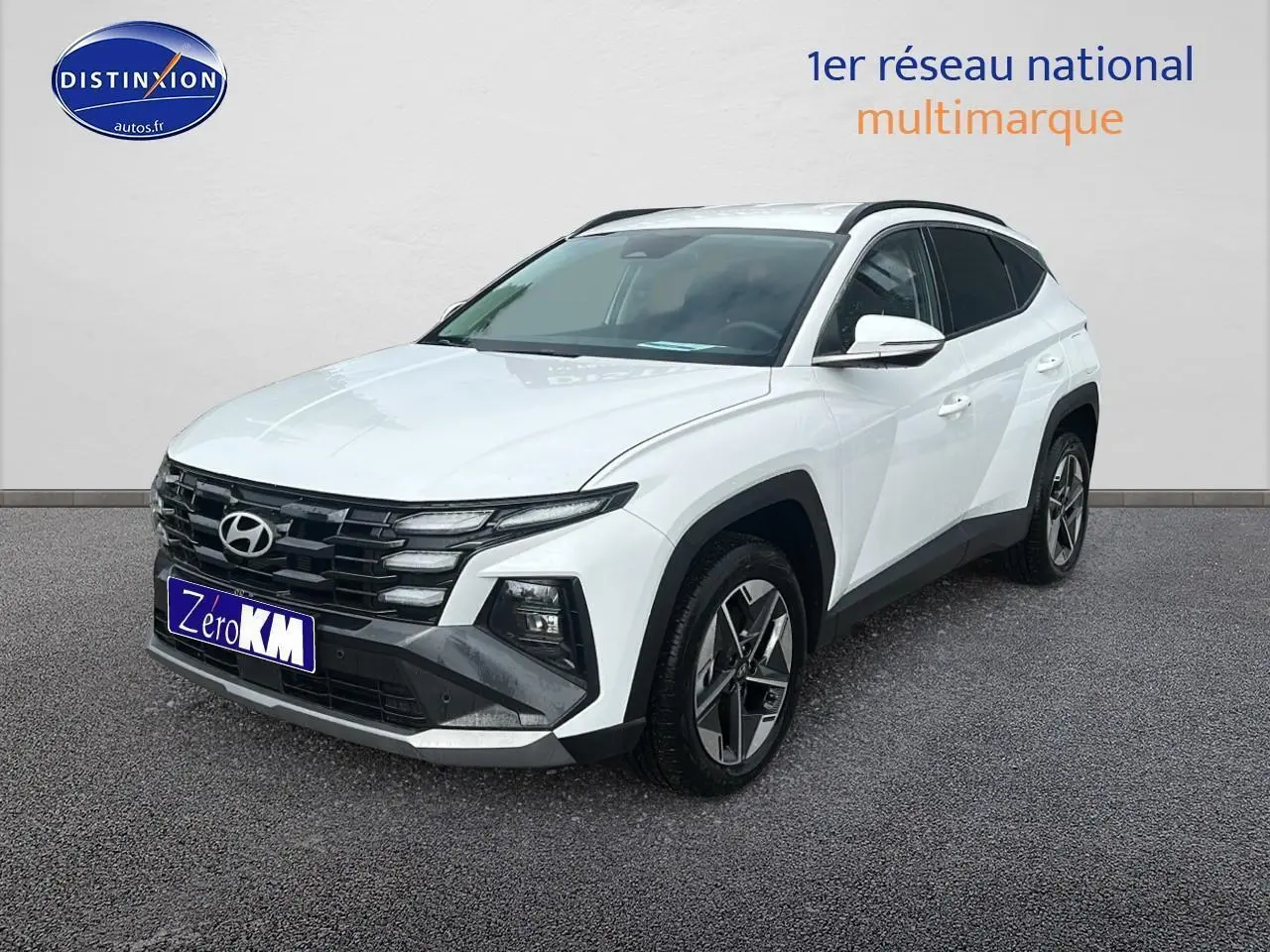 Hyundai Tucson 2025 blanc sérénité vu en 3/4 avant droit avec calandre noire et jantes alliage 18 pouces.