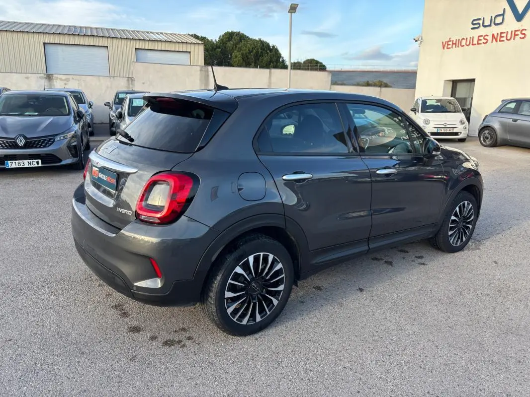 Vue 3/4 arrière droite d'une FIAT 500X MY23 gris avec jantes 16 pouces et feux arrière distinctifs en forme carrée.