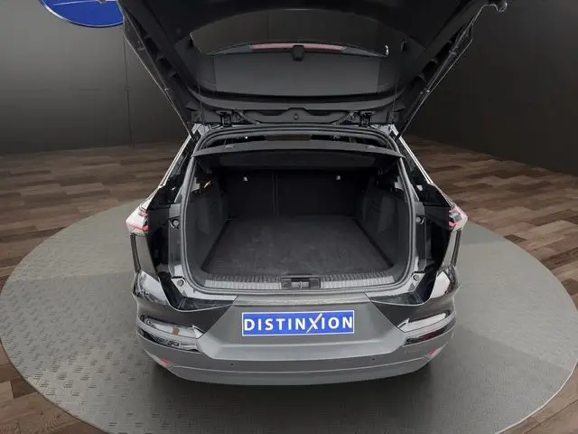 Vue arrière du Renault Symbioz noir 2025 avec coffre ouvert, montrant l’espace de chargement vide et la plaque Distinxion.