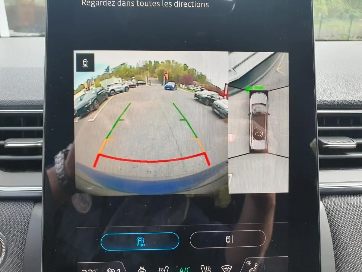 Écran de caméra de recul et vue 360° du Renault Captur bleu Iron, affiché depuis l'intérieur du véhicule.