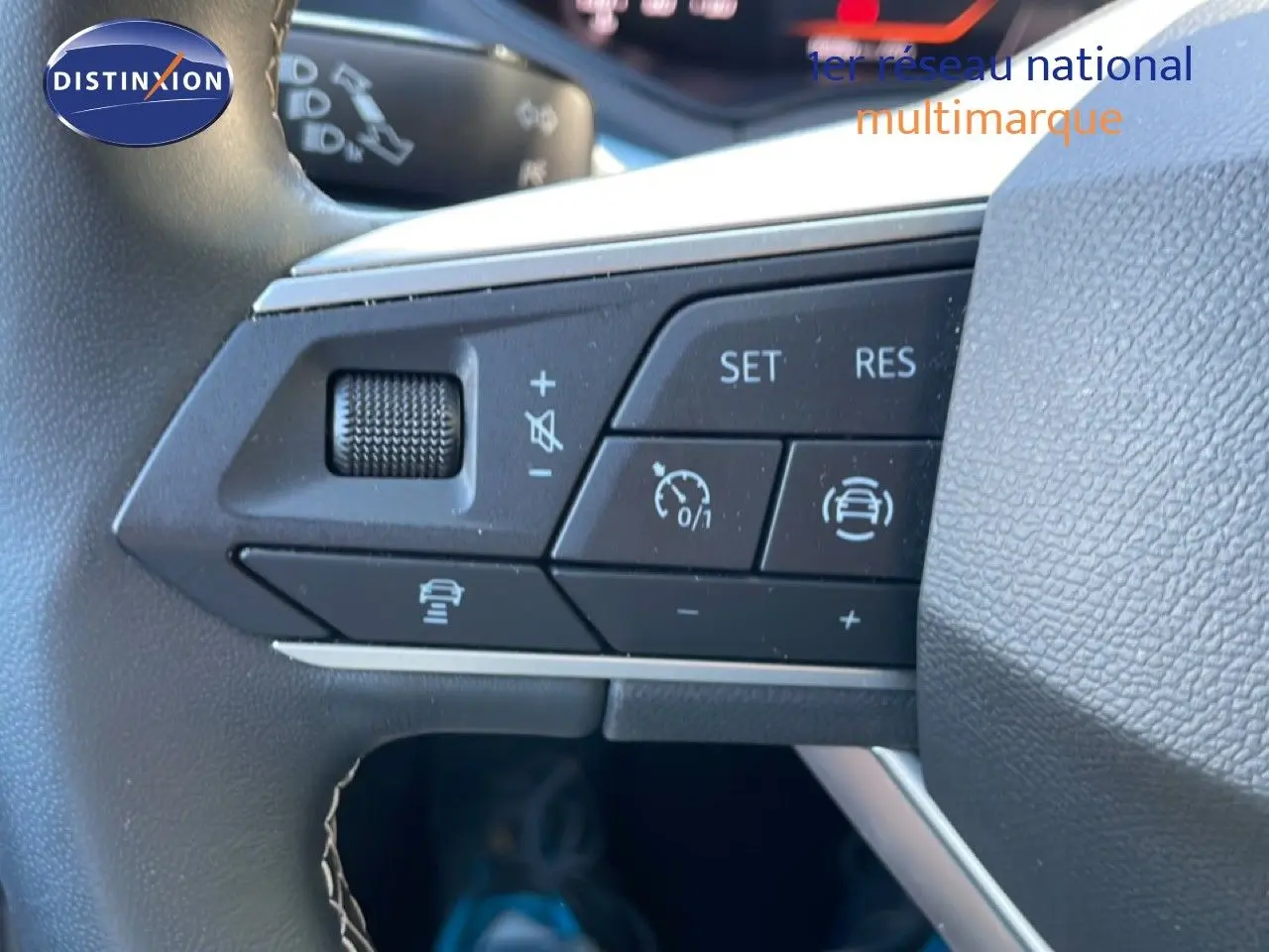 Gros plan sur les commandes de régulateur de vitesse au volant d'un SEAT Arona 2025, intérieur noir.