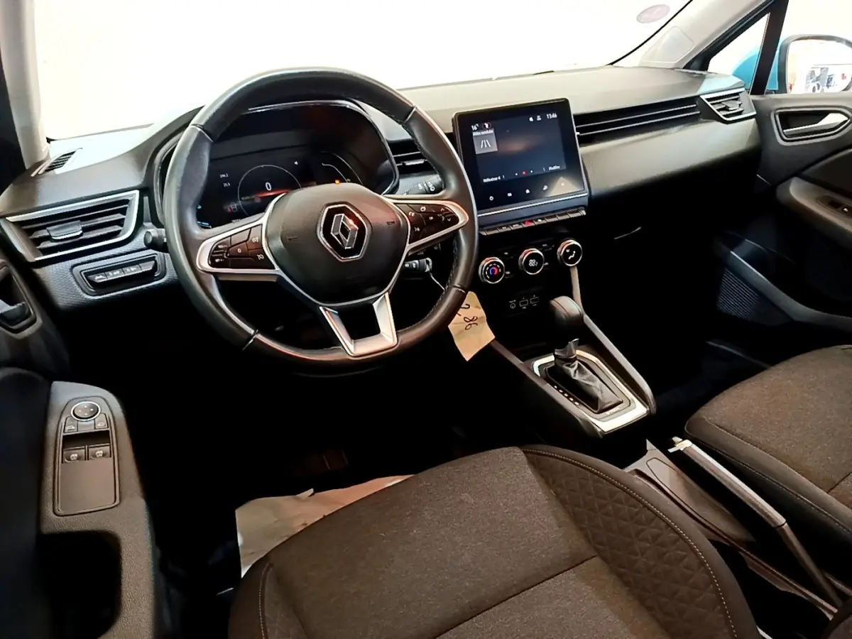 Vue intérieure avant droite de la Renault Clio Business E-Tech hybride 2021, volant cuir et écran tactile central.