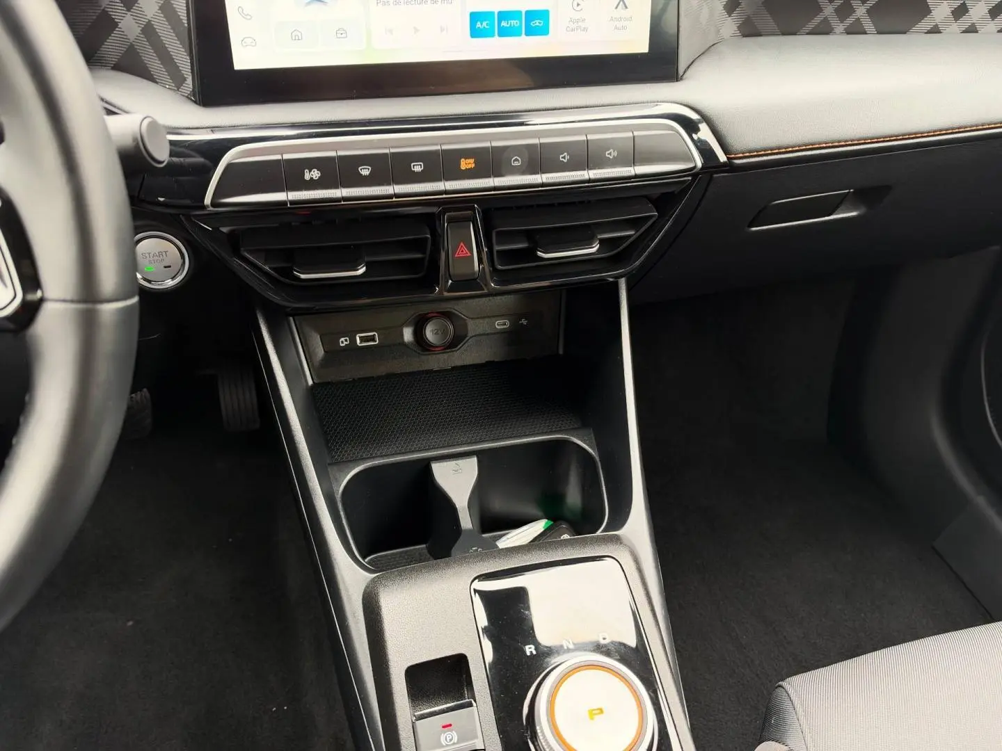 Vue intérieure centrée sur la console centrale et levier rotatif de boîte auto du MG3 1.5 Hybrid+ Luxury, finition noire.