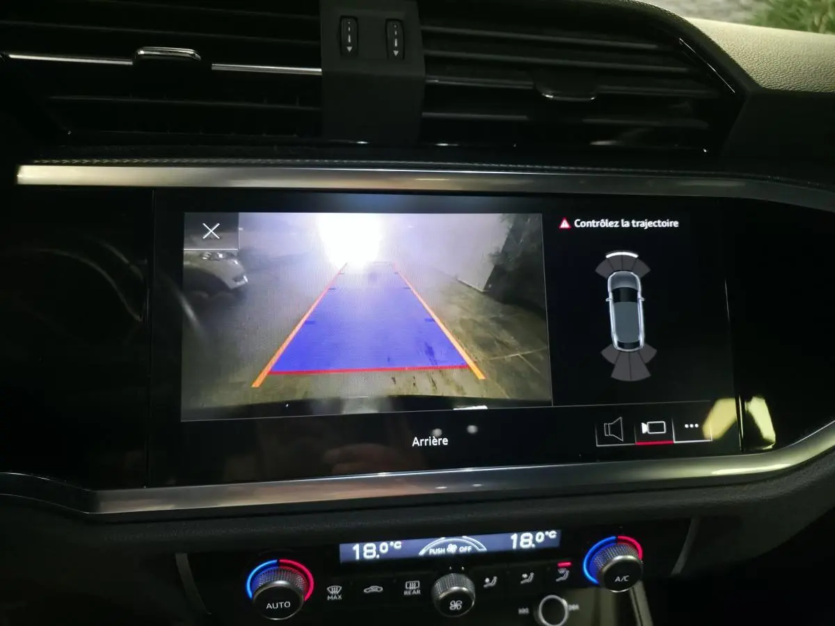 Vue intérieure du tableau de bord de l'Audi Q3 Sportback 2023, écran caméra de recul avec affichage de trajectoire.
