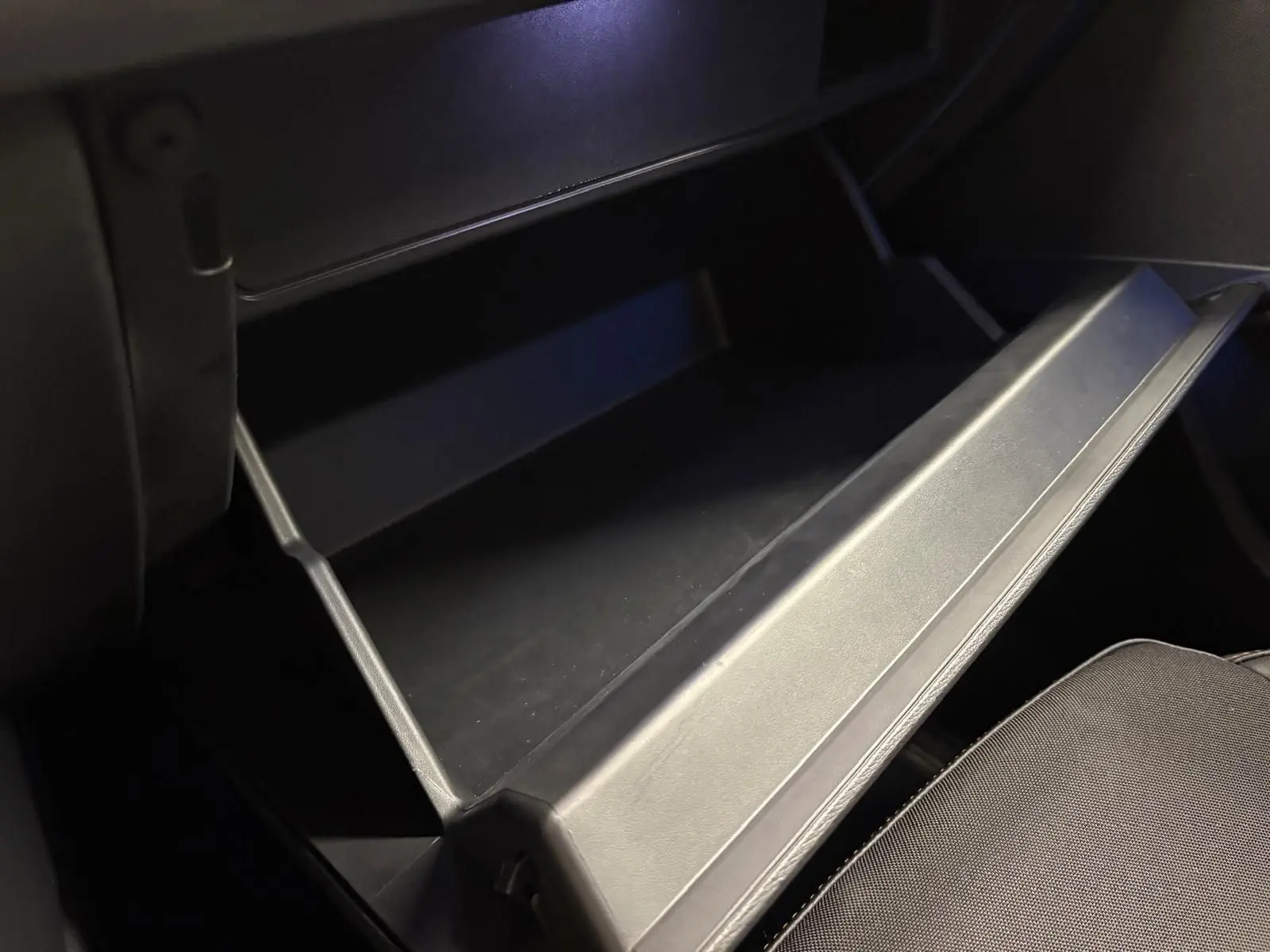 Gros plan sur la boîte à gants ouverte à droite dans l’habitacle noir du CUPRA Formentor 2024 Noir Minuit.