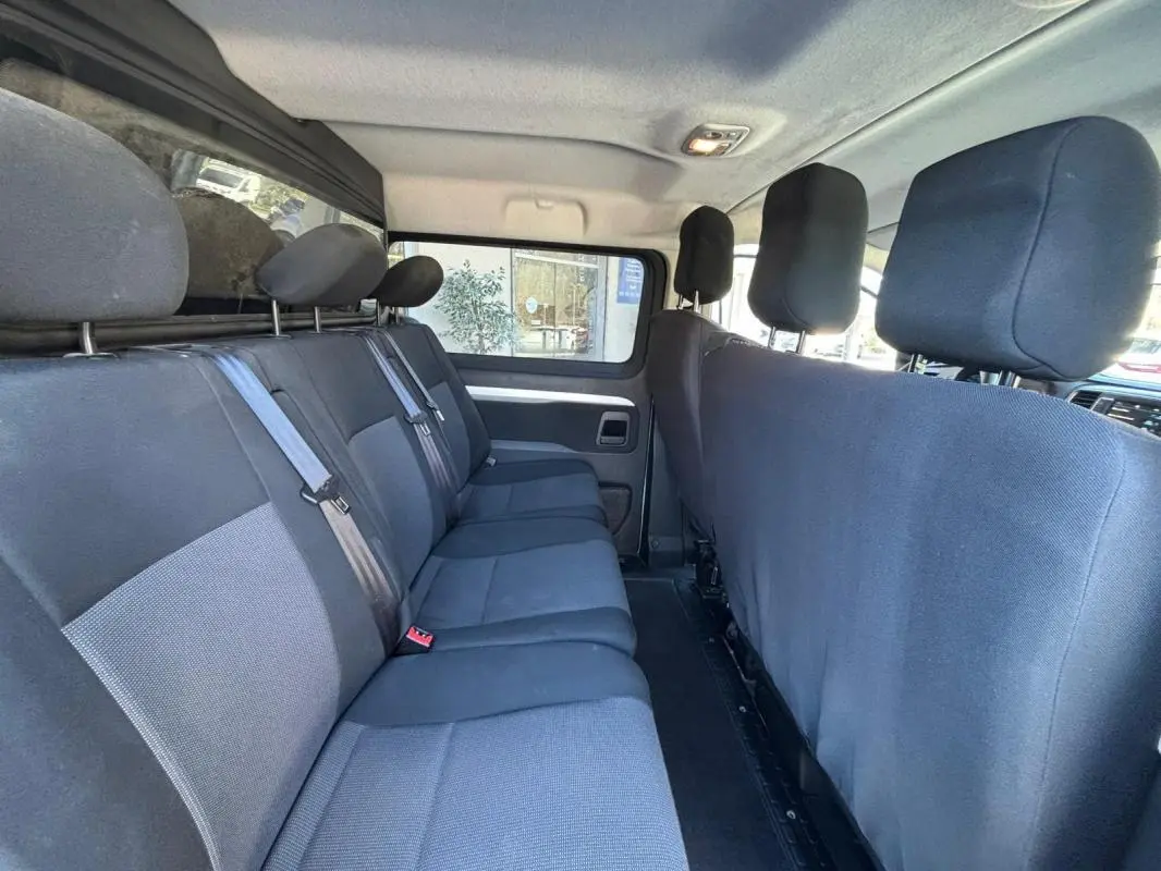 Vue intérieure du Peugeot Expert Fourgon blanc 2018, montrant la banquette arrière en tissu gris côté droit.