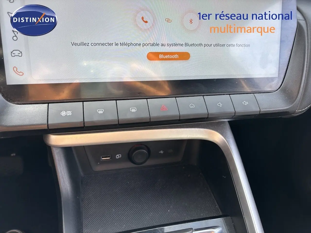 Gros plan sur la console centrale du MG ZS 1.5L Hybrid+ 2025, avec écran tactile et rangements en Pebble Black Metal.