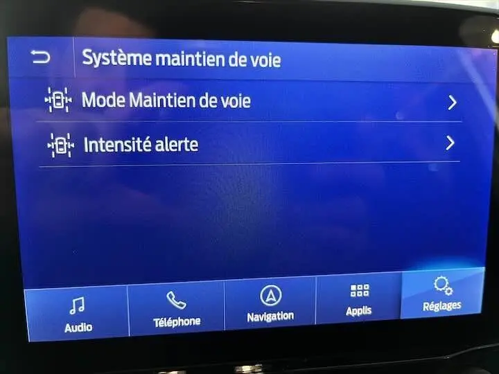 Écran tactile intérieur du Ford Puma blanc glacier 2022 affichant les réglages du système de maintien de voie.