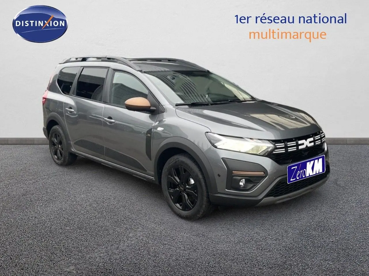 Vue 3/4 avant gauche d'un Dacia Jogger gris schiste métallisé avec jantes noires et rétroviseurs couleur cuivre.