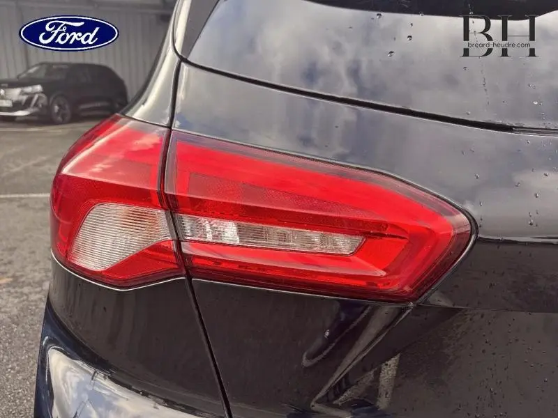 Gros plan sur le feu arrière droit d'une Ford Focus 2019 noir Shadow avec carrosserie brillante et gouttes d'eau visibles.