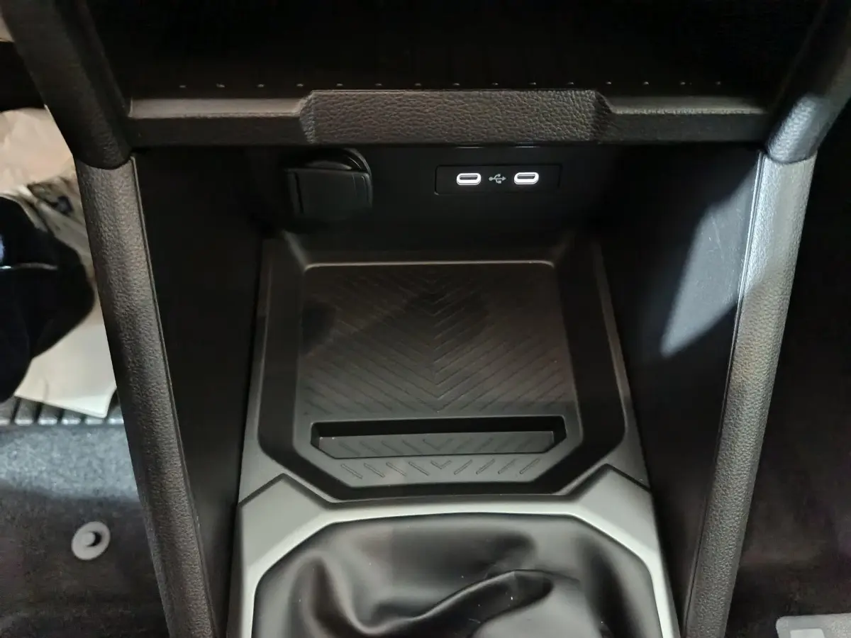 Gros plan sur la console centrale noire du Dacia Bigster 2025, montrant les ports USB et un espace de rangement antidérapant.
