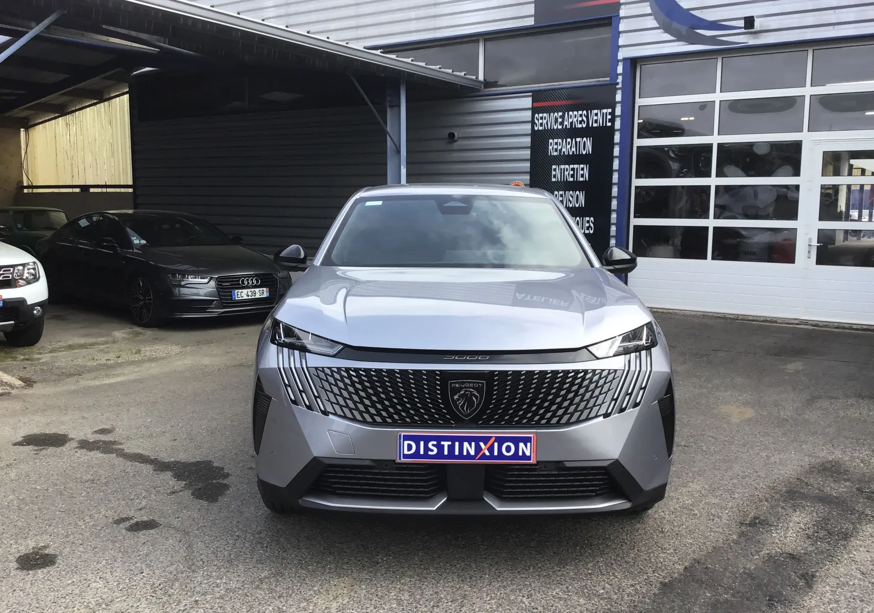 Vue de face du Peugeot 3008 1.2 HYBRID 145 en gris Artense, soulignant sa calandre moderne et son logo lion central.