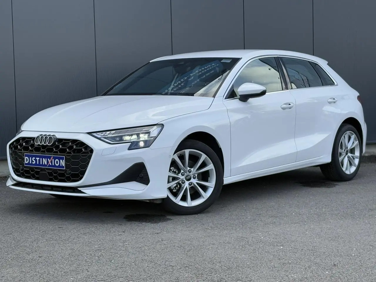 Audi A3 Sportback blanc Arkona vue 3/4 avant droit, avec calandre noire et jantes alliage 17 pouces.