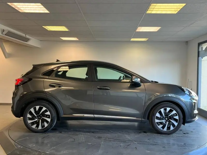 Profil droit du Ford Puma 2022 gris métallisé Fashion Gris Magnetic, avec jantes alliage et rétroviseurs noirs.