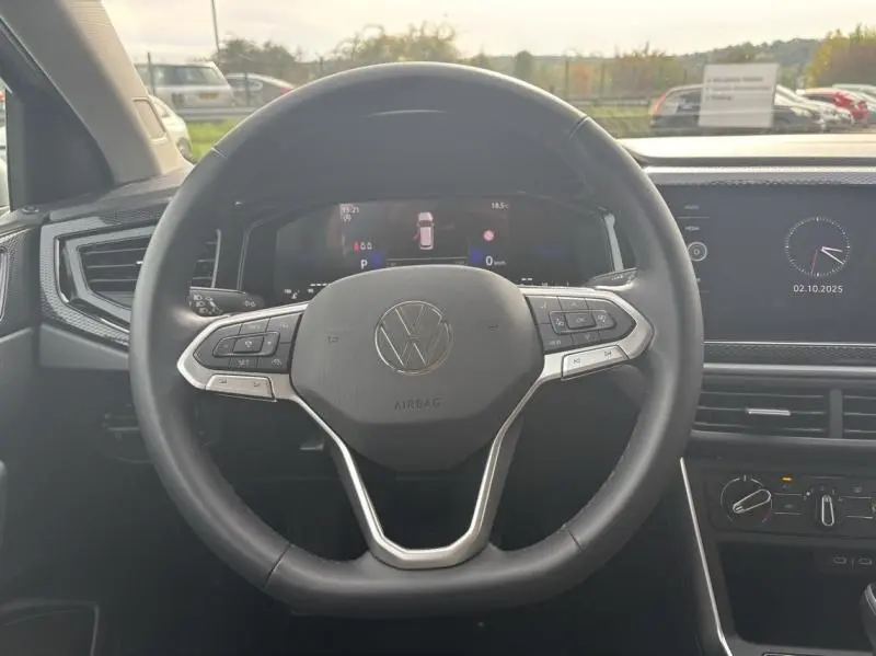 Vue frontale du volant cuir multifonction du Volkswagen Taigo 2025, avec tableau de bord digital et écran tactile visible.