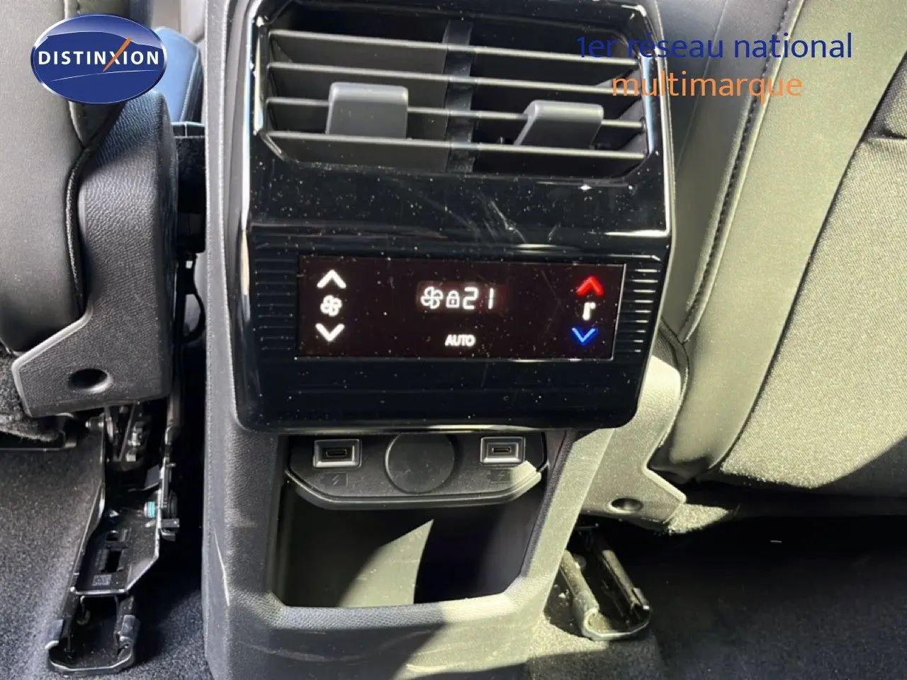 Vue rapprochée de la console arrière du Peugeot 5008 gris Artense, affichant la climatisation et deux ports USB.