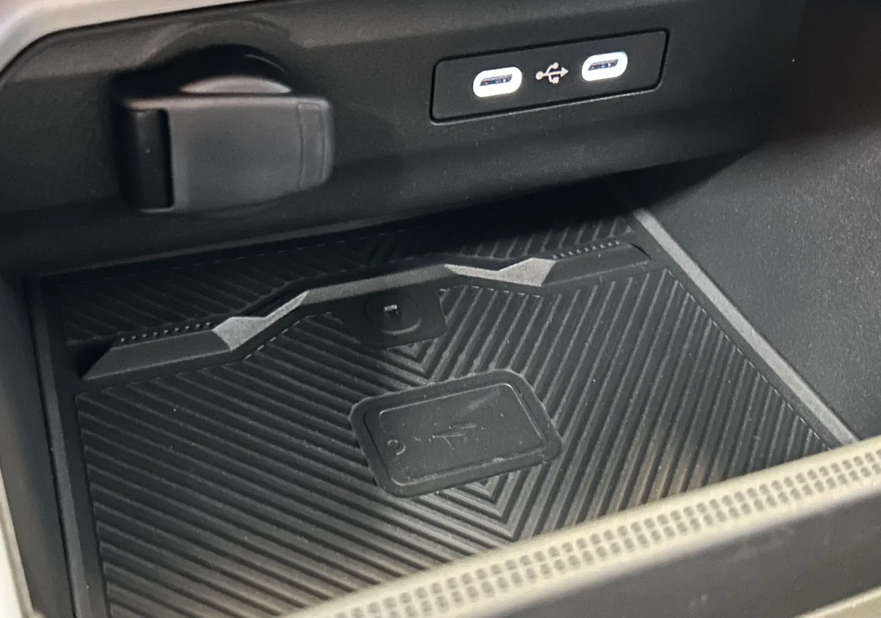 Gros plan sur le chargeur sans fil et ports USB-C dans l'habitacle du Dacia Bigster 2026 noir nacré.