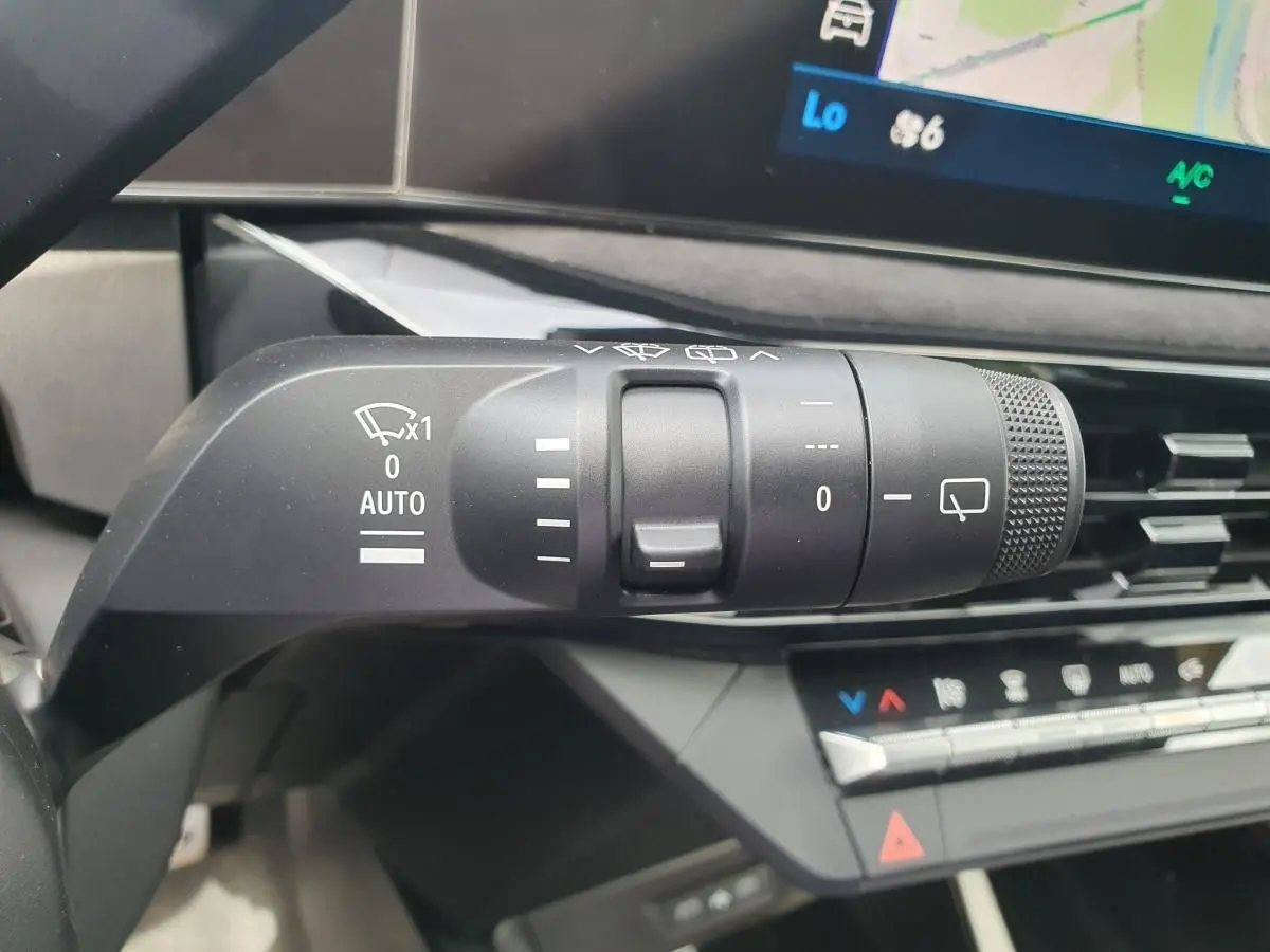 Gros plan sur la commande des essuie-glaces dans l’habitacle gris de la Renault Clio VI hybride 2026.