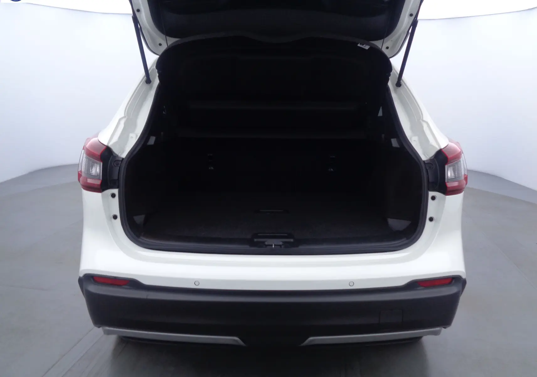 Vue arrière du Nissan Qashqai blanc lunaire métal 2020 avec coffre ouvert et intérieur de chargement visible.