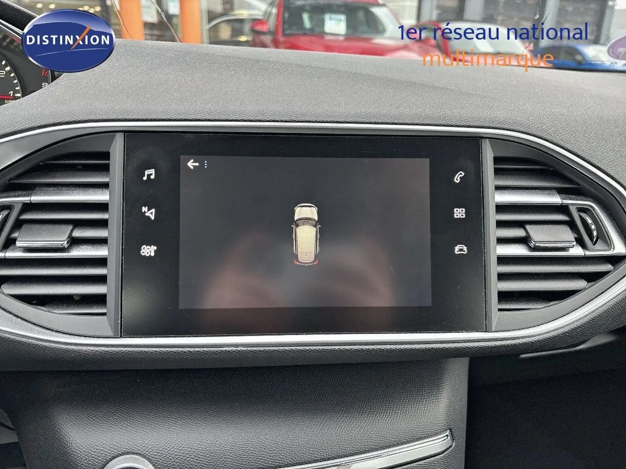 Vue rapprochée de l'écran tactile central du tableau de bord de la Peugeot 308 gris Artense, affichant la caméra de recul.