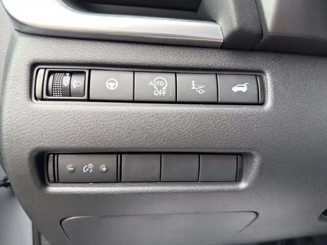Gros plan sur les commandes noires du tableau de bord du Nissan Qashqai 2025 Ceramic Grey, avec bouton hayon motorisé.