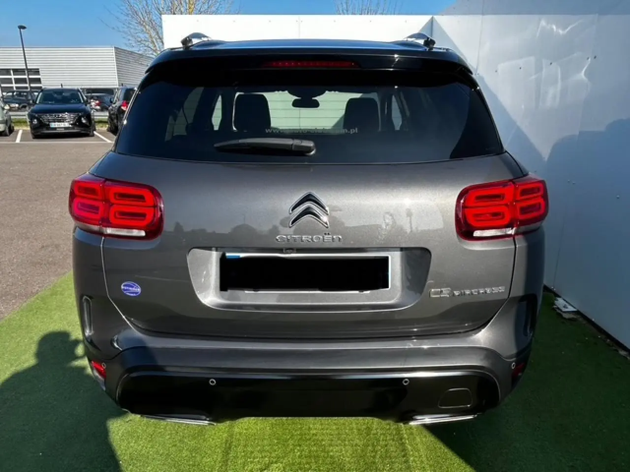 Vue arrière d'un Citroën C5 Aircross gris platinium métallisé avec feux arrière LED et hayon fermé.