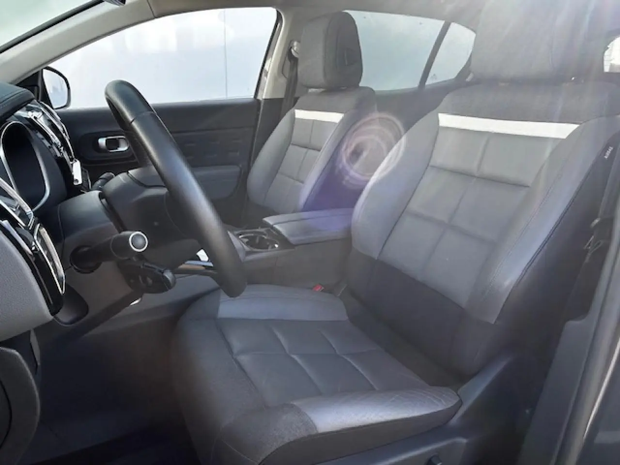 Vue intérieure côté conducteur du Citroën C5 Aircross 2019, sièges cuir gris avec bande claire et accoudoir central.