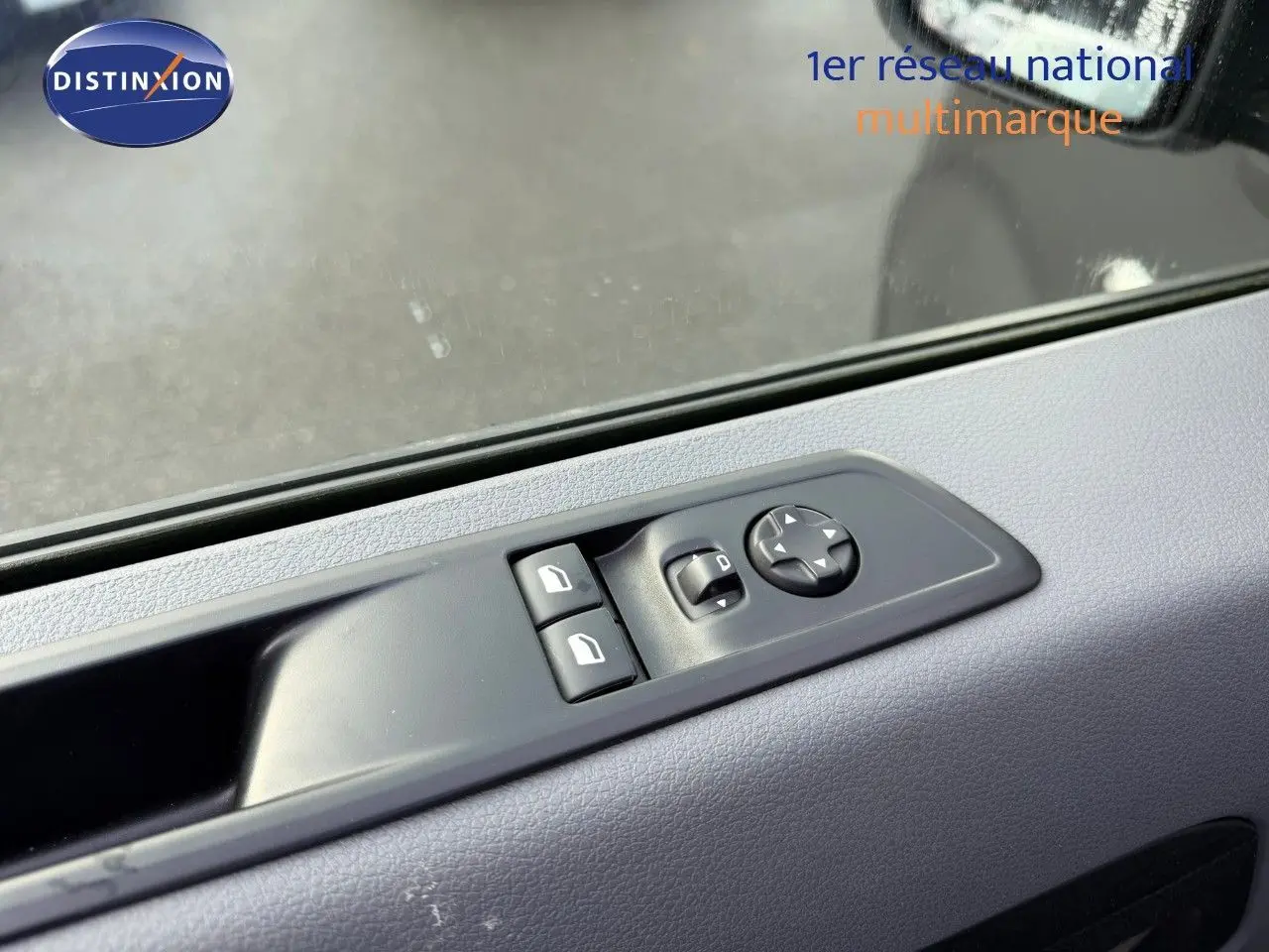 Gros plan sur les commandes de réglage des vitres et des rétroviseurs côté gauche d’un Opel Vivaro gris titane 2020.