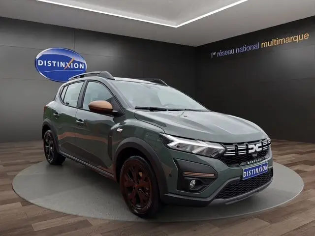 Vue 3/4 avant d'une Dacia Sandero Stepway 2025 kaki lichen avec détails bronze sur les rétroviseurs et jantes noires.