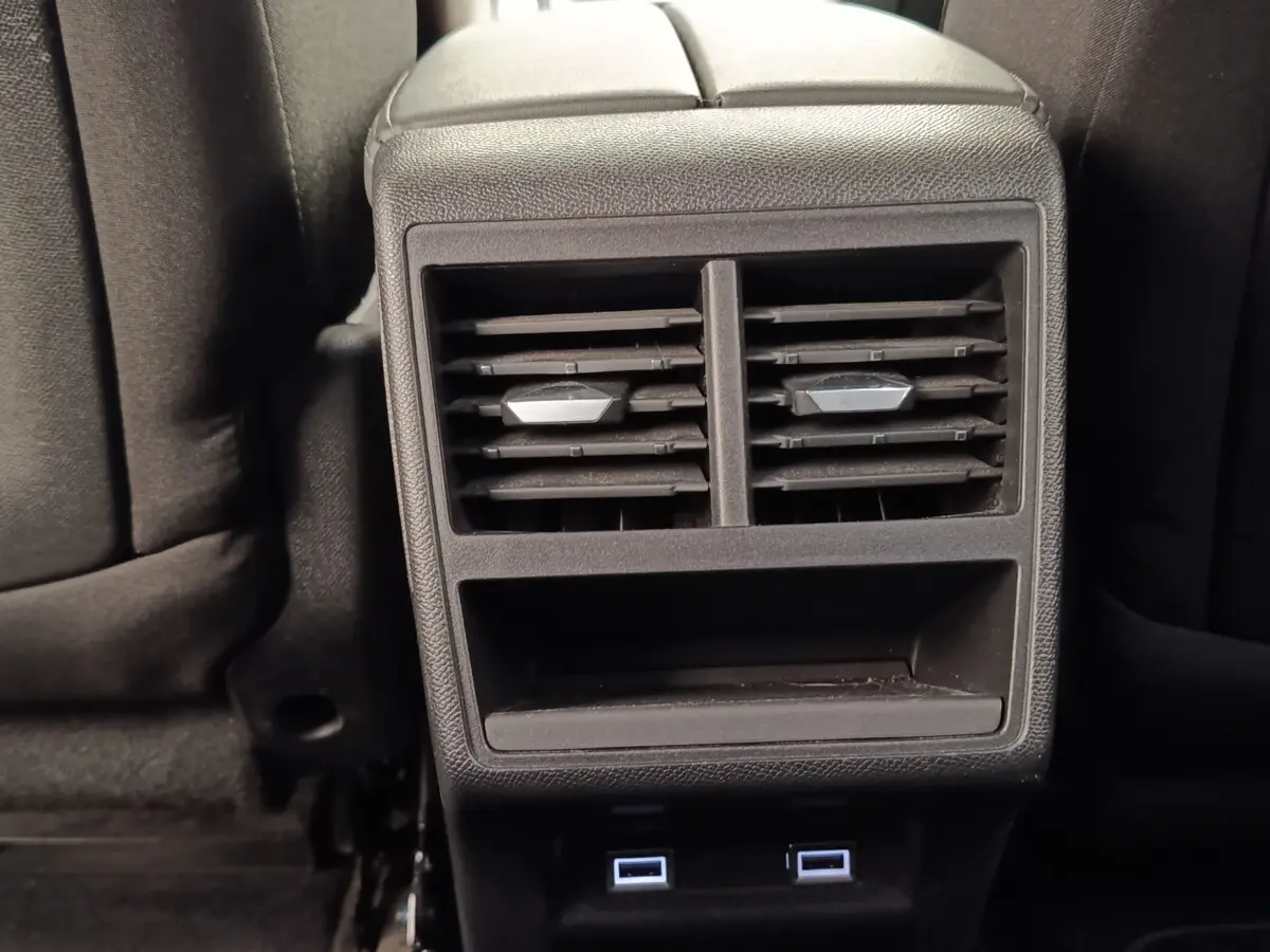 Gros plan sur la console arrière noire avec bouches d’aération et ports USB du DS7 Crossback E-TENSE 225 gris clair.