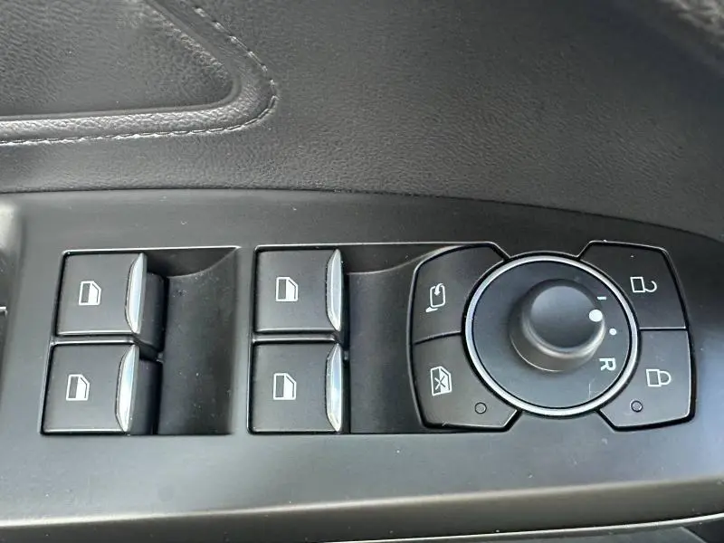 Panneau de commandes des vitres et rétroviseurs côté conducteur dans une Ford Focus 2023 noir Agate métallisé.