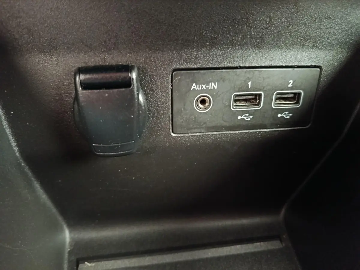 Vue rapprochée des ports USB et prise Aux-IN noirs dans l’habitacle d’une Renault Clio Business E-TECH 140 blanche.