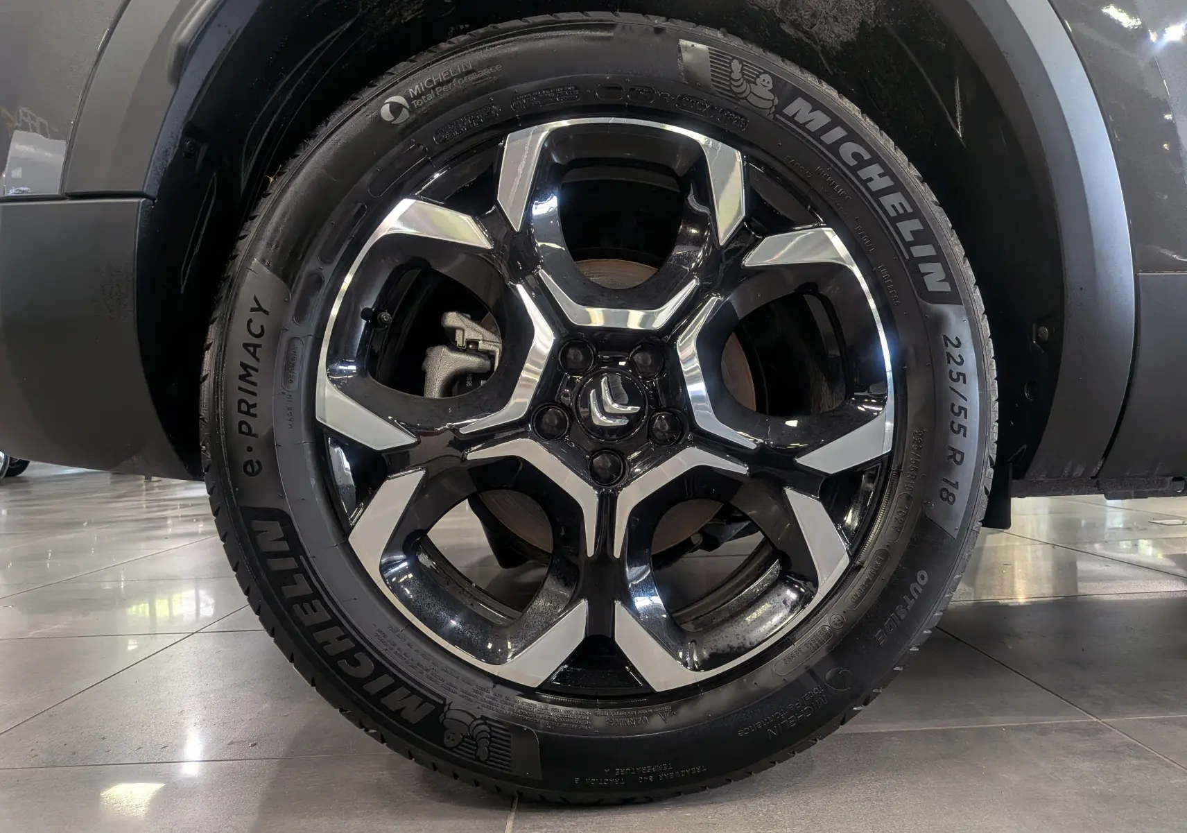 Gros plan sur la jante noire et argentée de 18 pouces d'un Citroën C5 Aircross Gris Platinium, avec pneu Michelin visible.